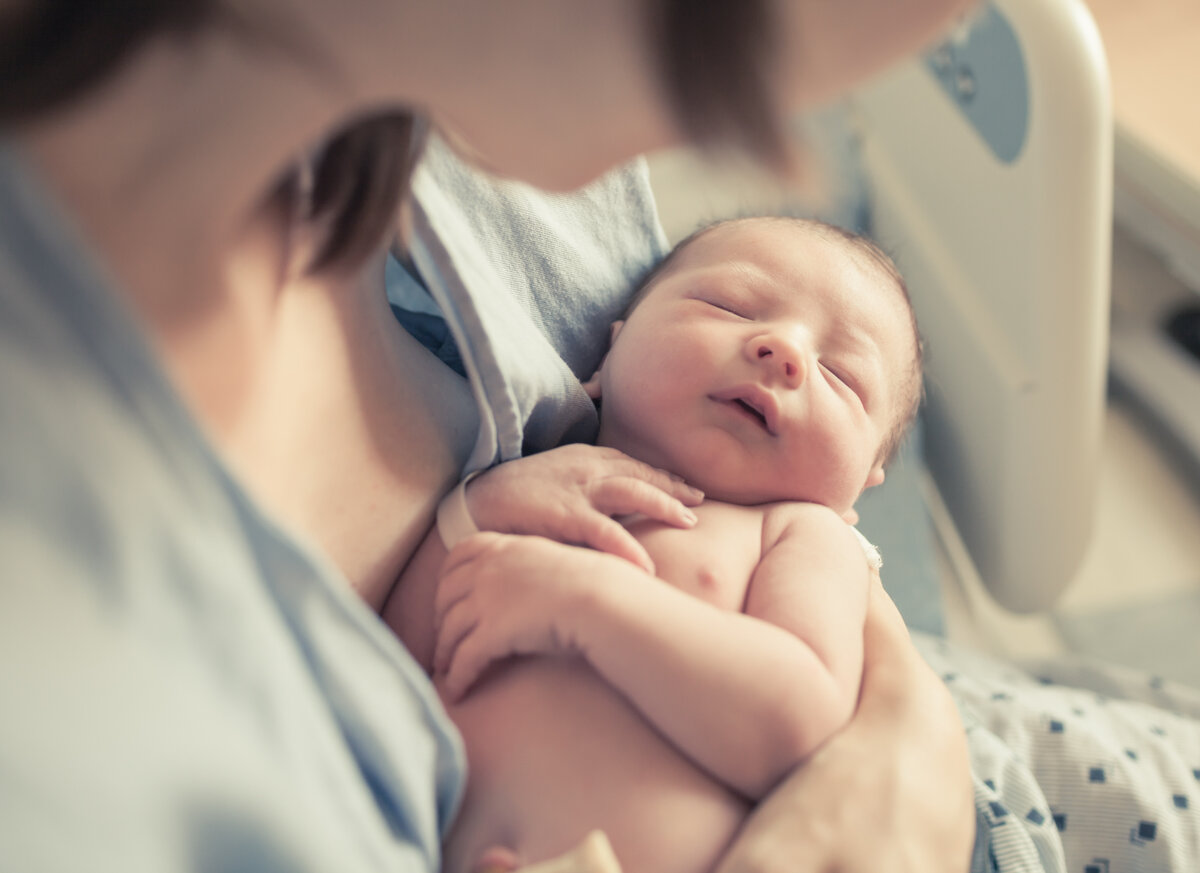 Parenting and new life concept. Mother holding newborn baby boy 